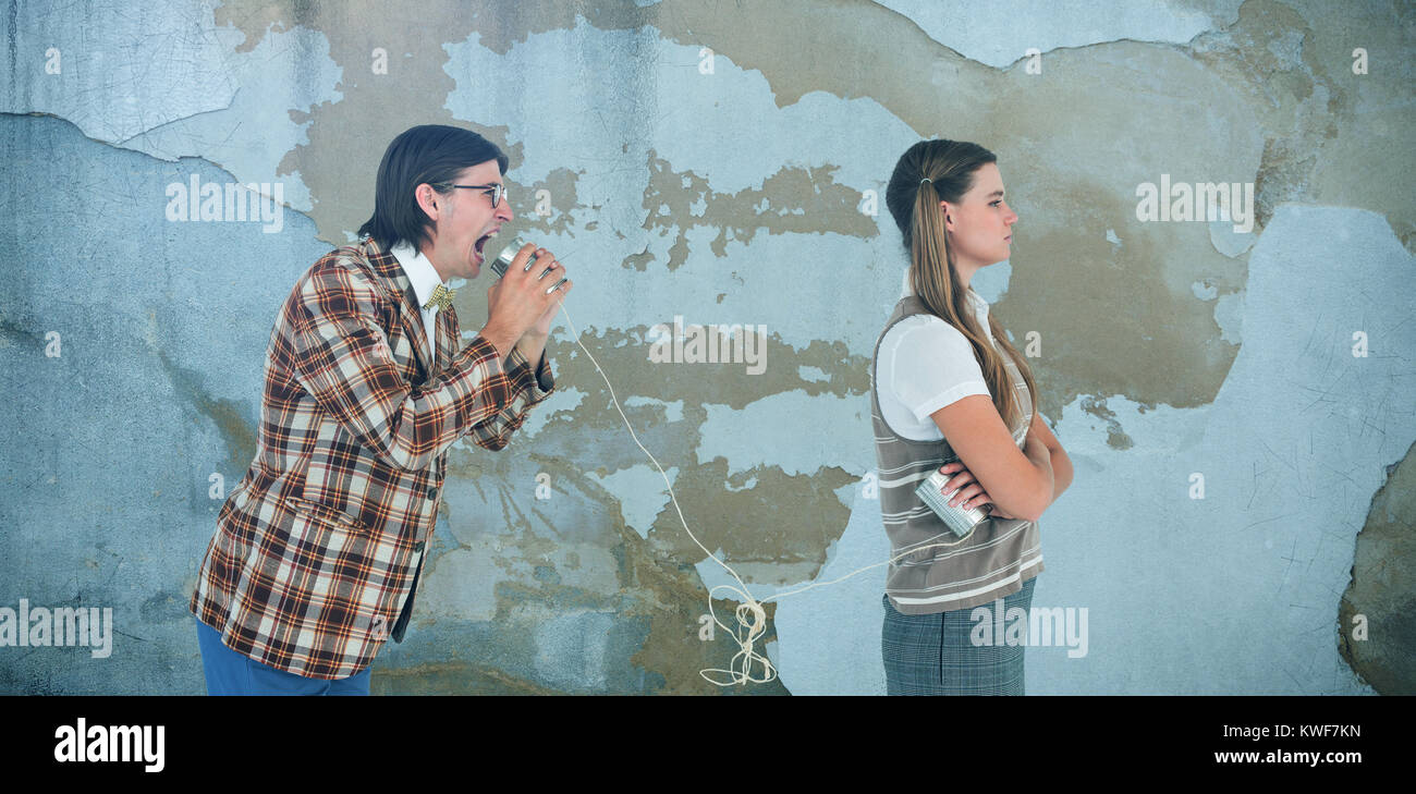 Composite image of geeky hipsters using string phone Stock Photo