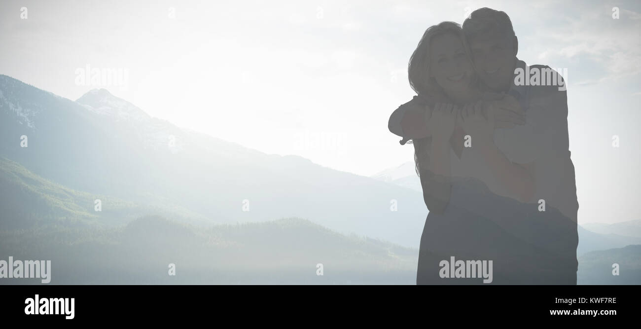 Composite image of mature couple embracing while smiling Stock Photo