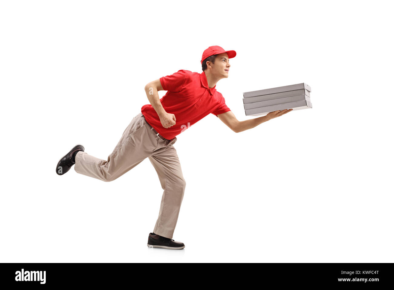 Full length profile shot of a teenage pizza delivery boy running isolated on white background Stock Photo