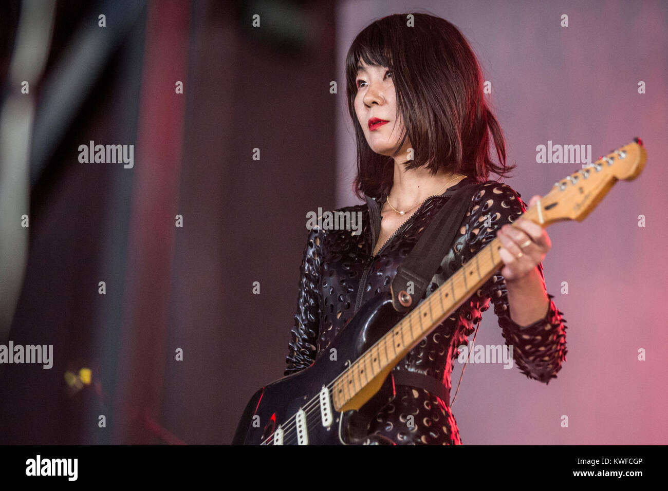 The American singer, songwriter and musician St. Vincent and performs a live concert at the Arena Stage at Danish music festival Roskilde Festival 2015. Here live band member Toko Yasuda is pictured live on stage. Denmark, 02/07 2015. Stock Photo