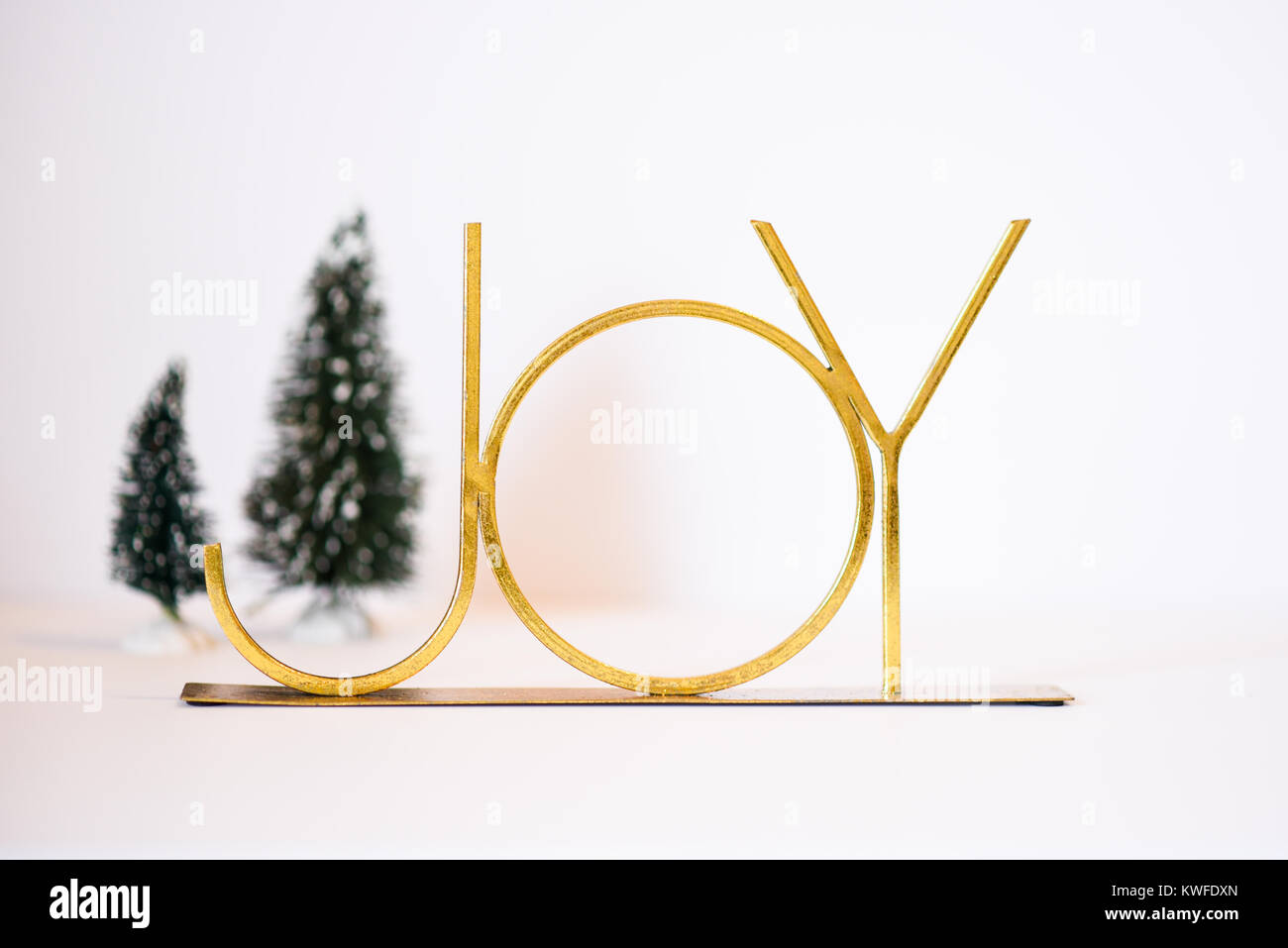 Christmas scene featuring a gold JOY and Christmas trees Stock Photo