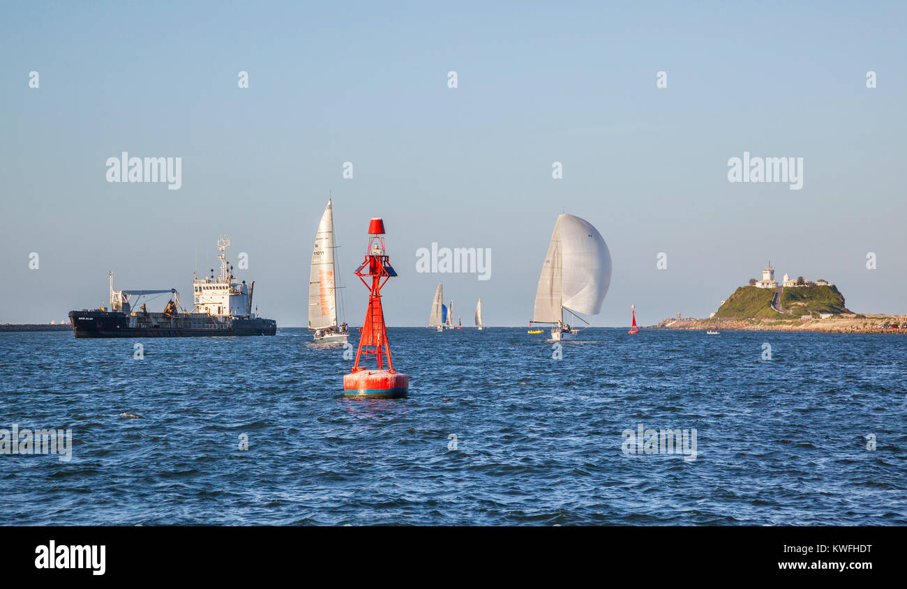 Australia, New South Wales, ships and yachts entering Newcastle Harbour with view of Nobbys Head Stock Photo