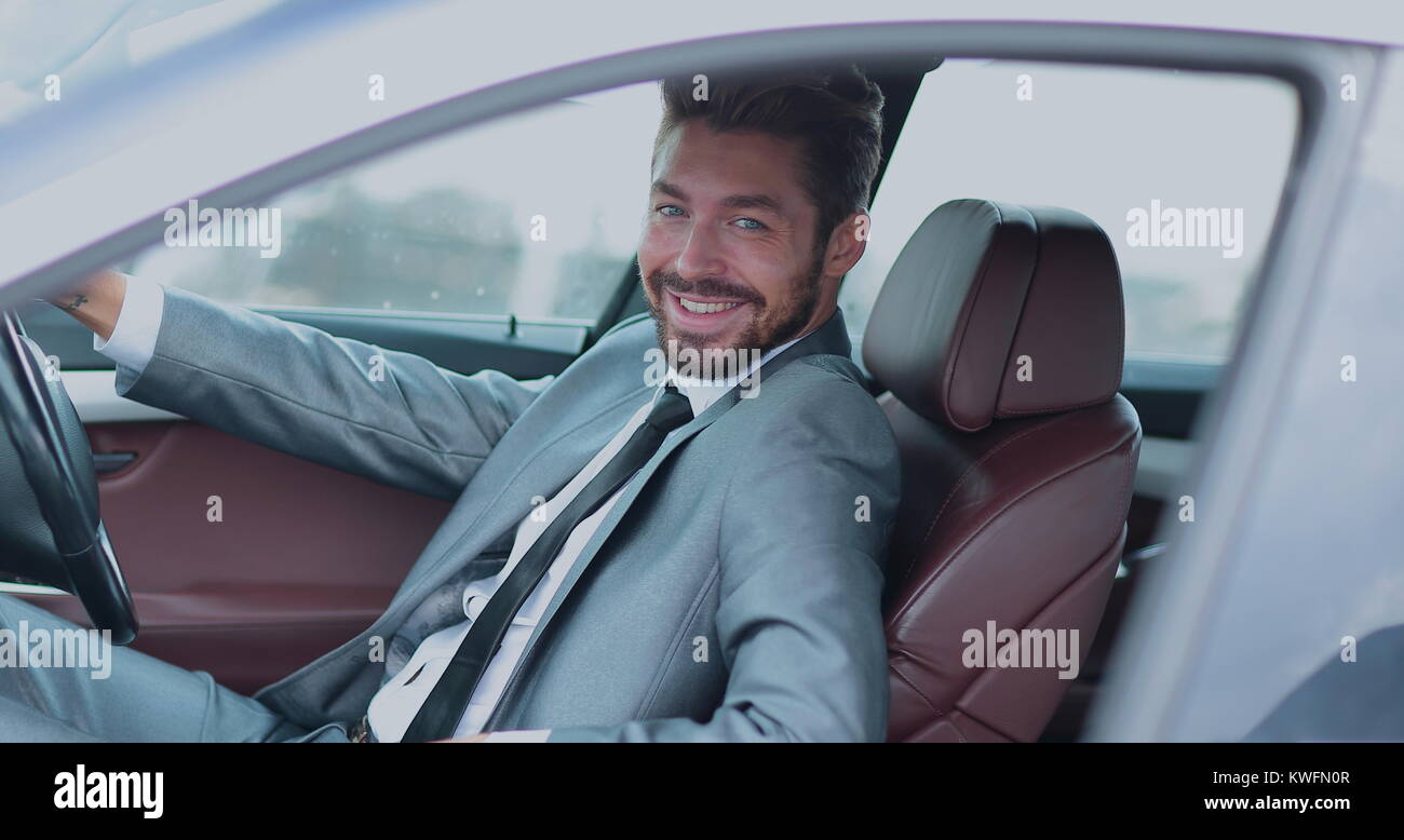 Portrait of an handsome smiling business man driving his car Stock ...