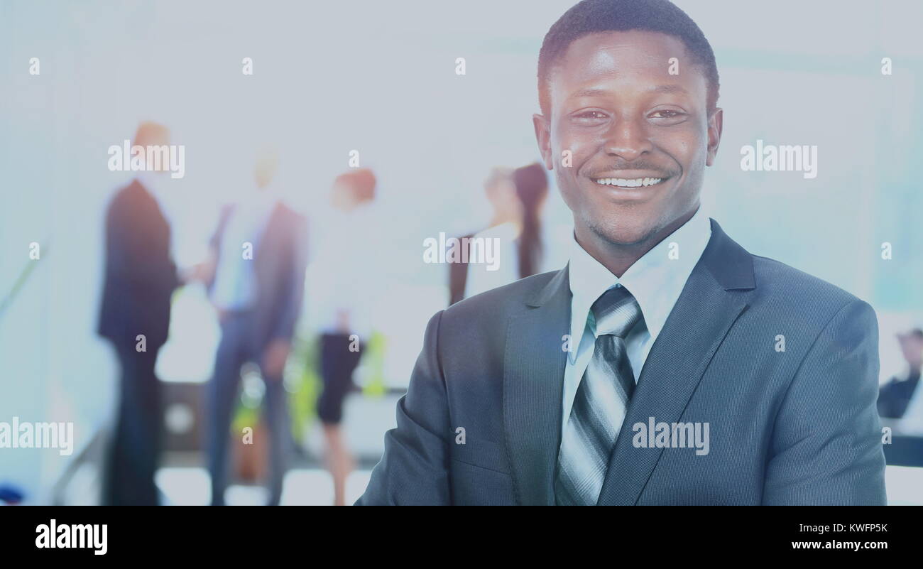 Confident business man with his team behind Stock Photo - Alamy