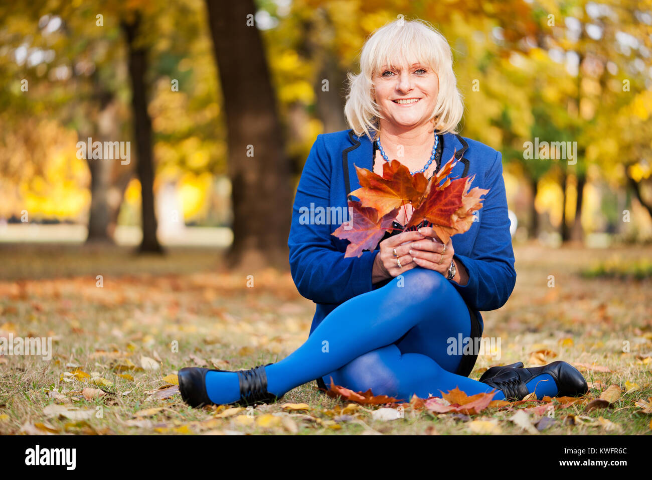 Mature woman autumn leaves hi-res stock photography and images - Alamy
