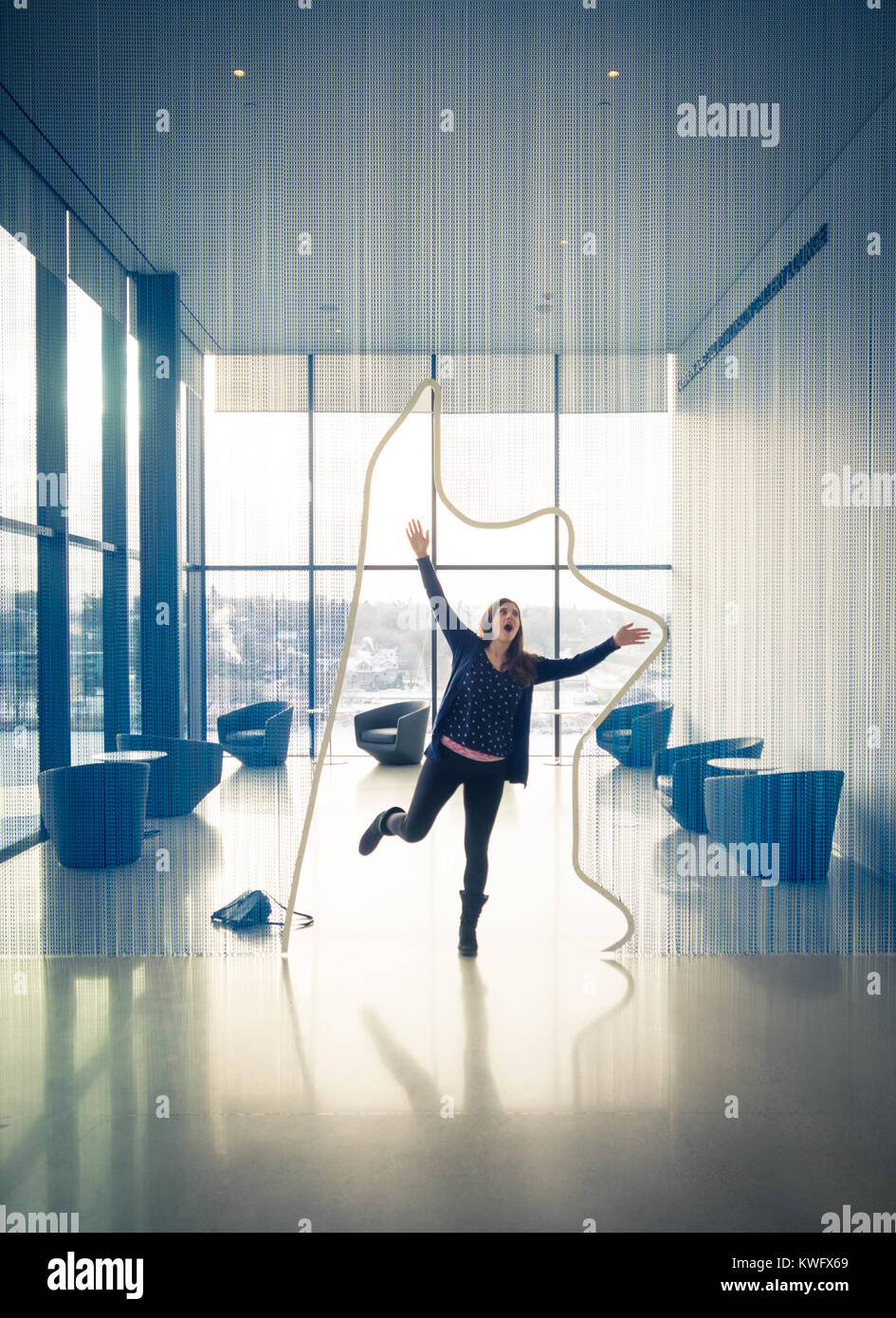 A young woman interacts with the art at the Remai Modern Art Gallery of Saskatchewan (rRemai mModern) in Saskatoon, Saskatchewan, Canada. Stock Photo