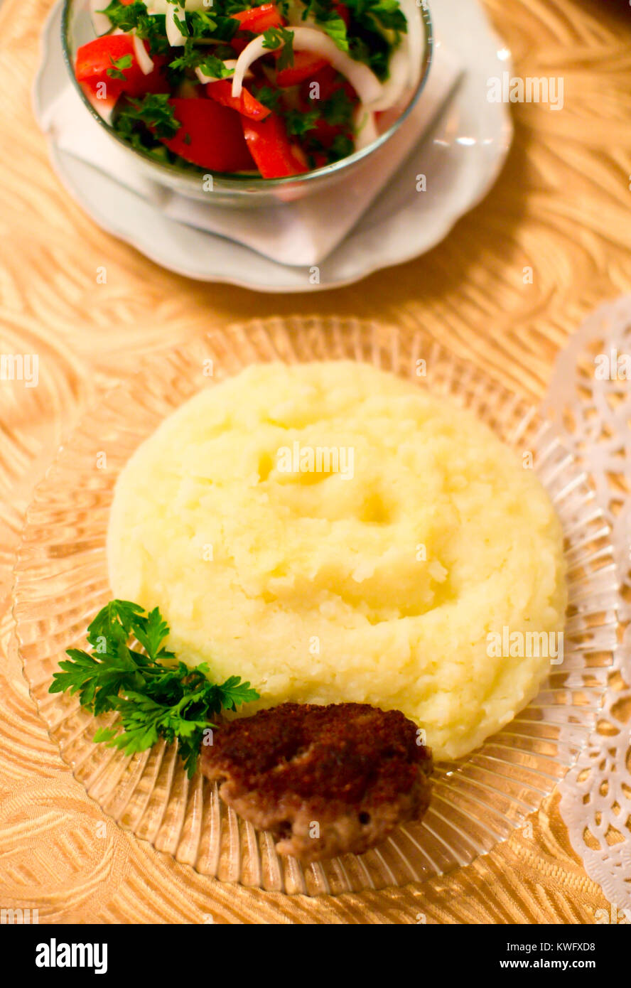 Mushed potato with cutlet and vegetable salad on table Stock Photo