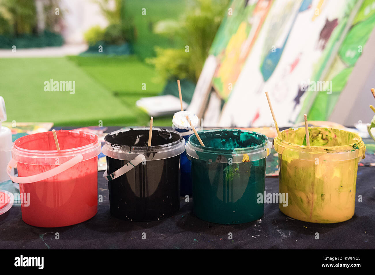 Used paint brushes with watercolor set Old paint cans and colors