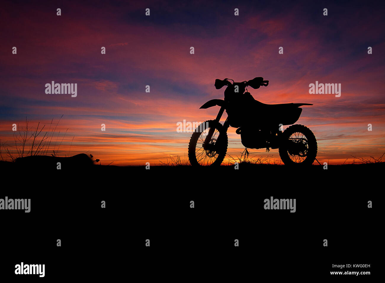 Dirtbike Silhouette On Top Of Hill During Sunset In Western Stock Photo 