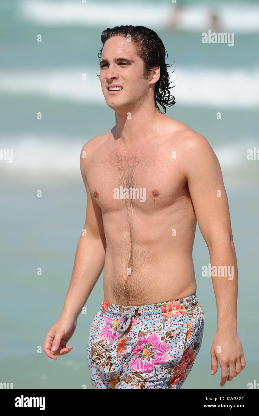 MIAMI BEACH, FL - MAY 24:  Diego Boneta studies his Rock Of Ages Script and than takes a swim on Miami Beach with an unidentified woman.   Diego AndrŽs Gonz‡lez Boneta (born November 29, 1990 in Mexico City) is a Mexican singer and actor. He is best known for playing Rocco in the Mexican soap opera Rebelde and recurring character Javier Luna in the series 90210. He recently recorded his self-titled debut album with his first single, Responde in 2005 and a Brazilian version for the album, with songs in Portuguese was recorded in 2006. At the moment, the album was released in Mexico, Brazil and  Stock Photo