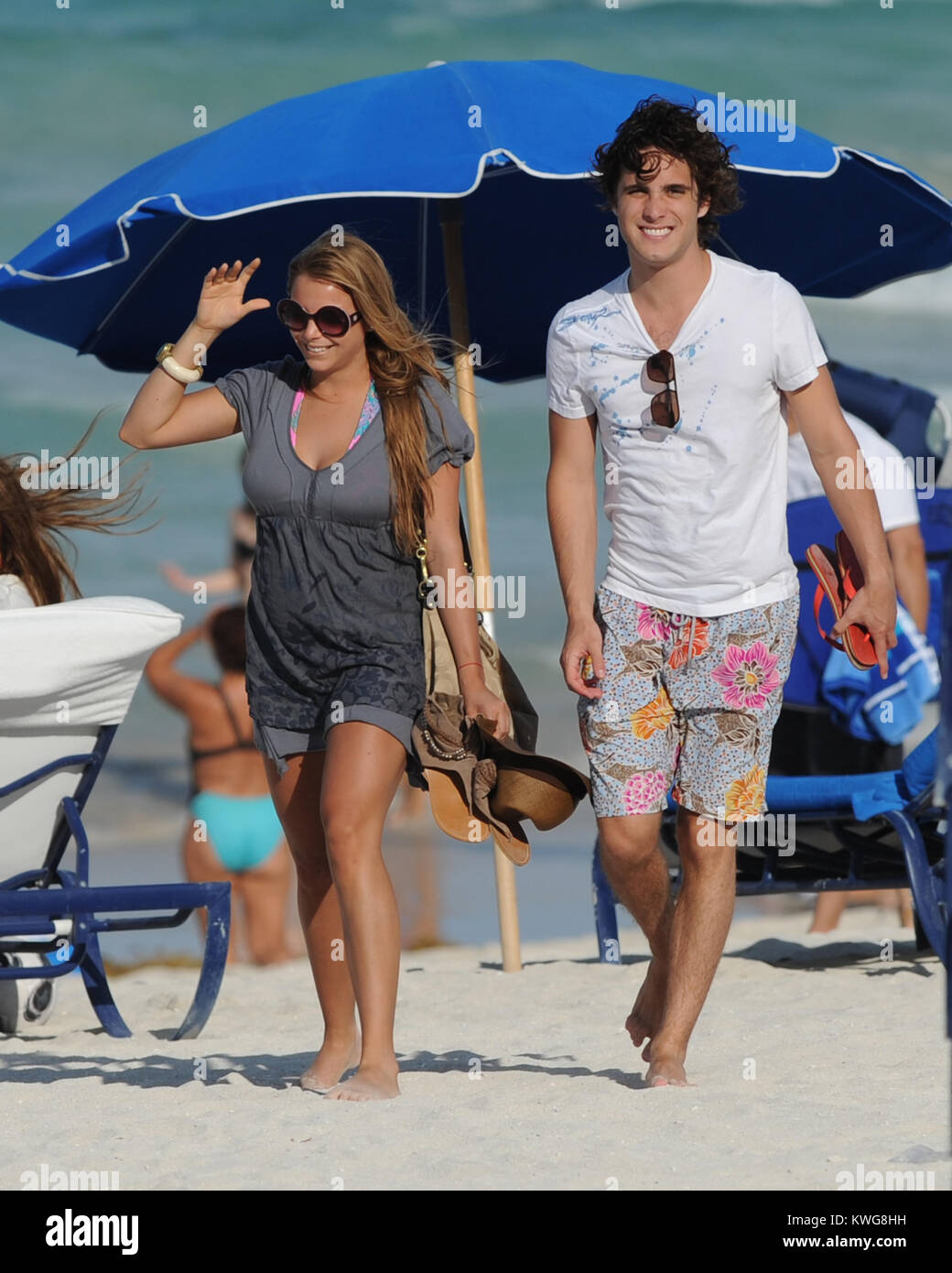 MIAMI BEACH, FL - MAY 24:  Diego Boneta studies his Rock Of Ages Script and than takes a swim on Miami Beach with an unidentified woman.   Diego AndrŽs Gonz‡lez Boneta (born November 29, 1990 in Mexico City) is a Mexican singer and actor. He is best known for playing Rocco in the Mexican soap opera Rebelde and recurring character Javier Luna in the series 90210. He recently recorded his self-titled debut album with his first single, Responde in 2005 and a Brazilian version for the album, with songs in Portuguese was recorded in 2006. At the moment, the album was released in Mexico, Brazil and  Stock Photo