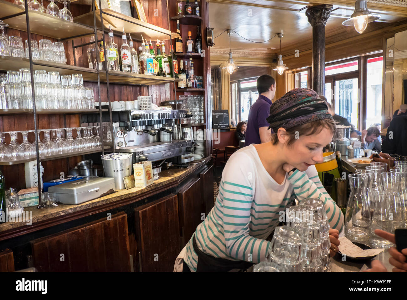 France, Paris, Young woman behind bar in the cafe La Marine Stock Photo