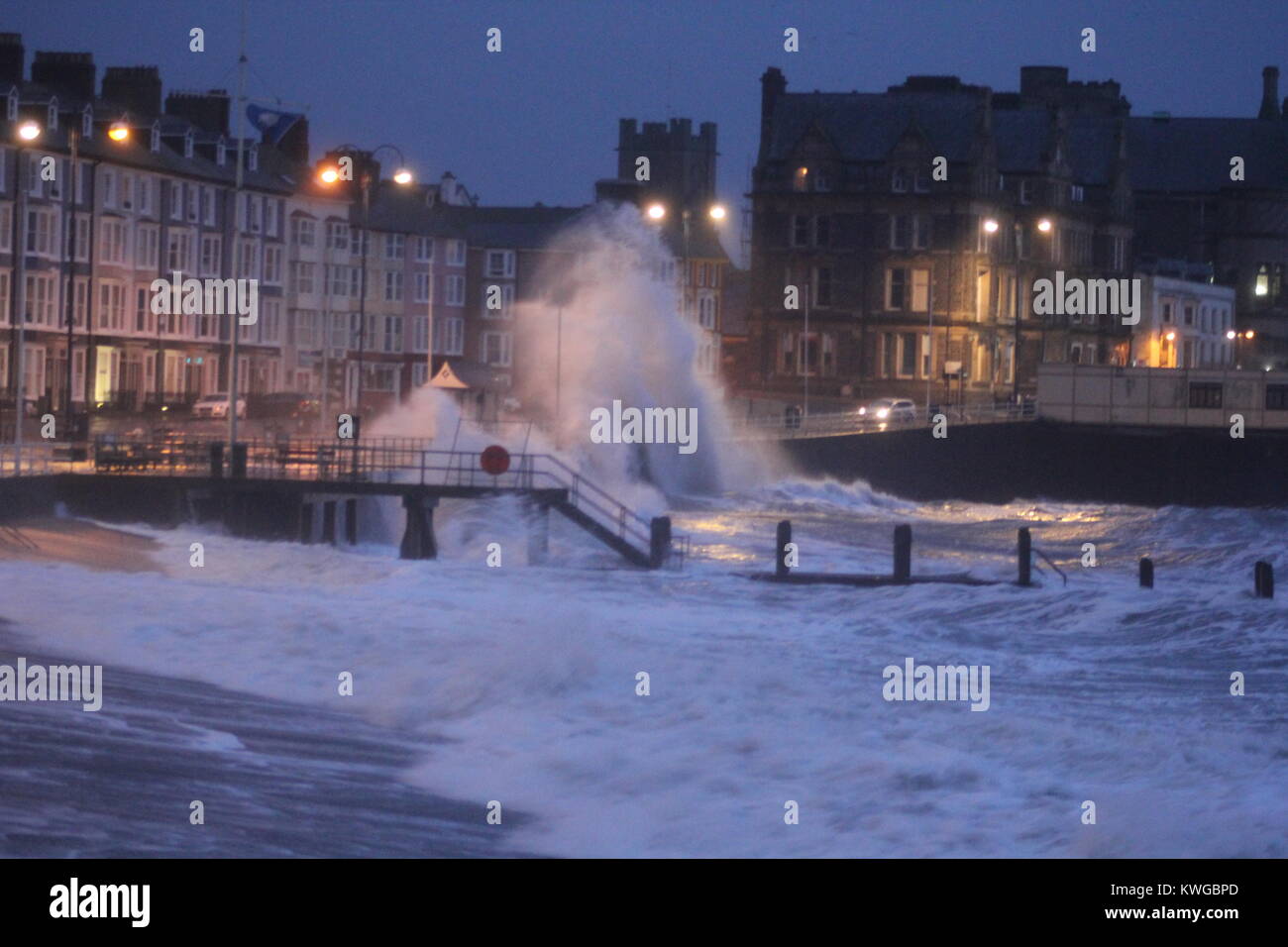 Aberystwyth Wales. 3rd Jan, 2018. UK Weather. Storm Eleanor hits the Welsh coast with gales & gusts up to 80 mph driving in huge waves & torrential rain which smash into the promenade & harbour wall, with more strong winds expected during the next day's Credit: mike davies/Alamy Live News Stock Photo