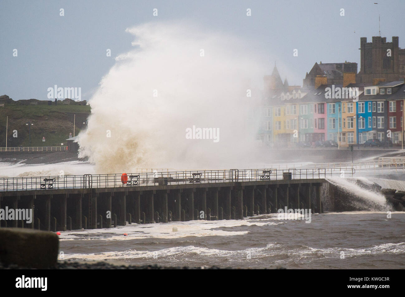 Aberystwyth Wales UK, Tuesday 03 January 2018 UK Weather : Storm Eleanor, the fifth named storm of the winter, hits Aberystwyth Wales, with westerly winds gusting up to 80mph bringing huge waves crashing against the sea defences and the seafront houses at high tide in the early morning Yellow warnings for wind and flooding have been issued by the Met Office for the whole of England and wales, with the risk of damage and disruption greatest on the western shores of the country photo Credit: Keith Morris/Alamy Live News Credit: keith morris/Alamy Live News Stock Photo