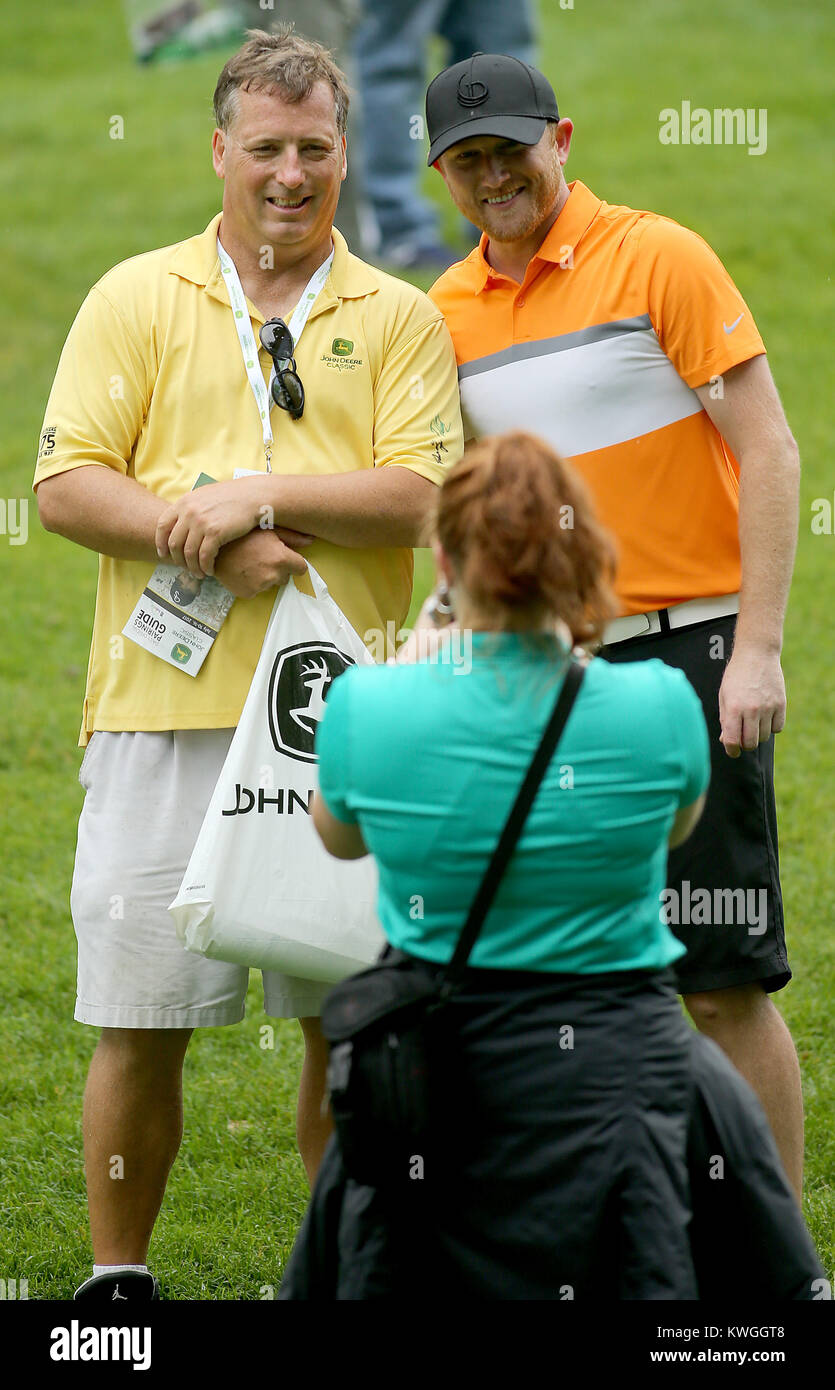 Silvis, Iowa, USA. 12th July, 2017. Marshal Smith of East Moline, gets his picture taken with country music performer Cole Swindell on the sixth green, Wednesday, July 12, 2017, during the John Deere Classic Pro-Am at TPC Deere Run in Silvis. Haley Delille of Coal Valley is taking the picture. Credit: John Schultz/Quad-City Times/ZUMA Wire/Alamy Live News Stock Photo