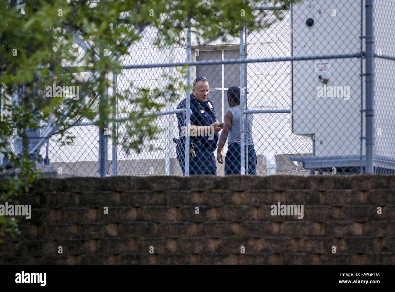 Davenport, Iowa, USA. 3rd Sep, 2016. Davenport Police Sgt. Eric Gruenhagen  shakes hands with the man who climbed the KWQC Channel 6 tower, in  Davenport on Saturday, September 3, 2016. Gruenhagen spent