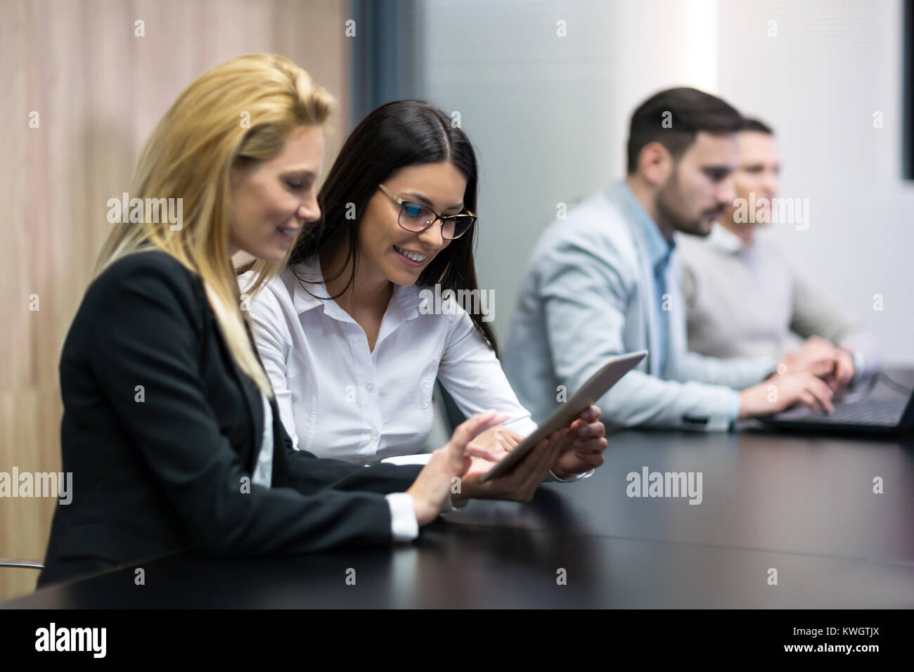 Two businesswomen having discussion in conference room Stock Photo