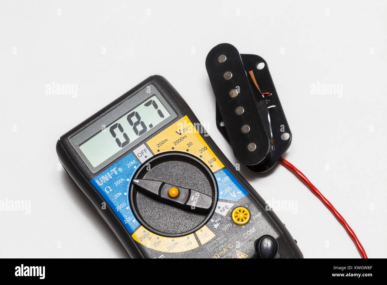 Testing the DC resistance on a telecaster type single coil guitar bridge  pickup using a multimeter Stock Photo - Alamy
