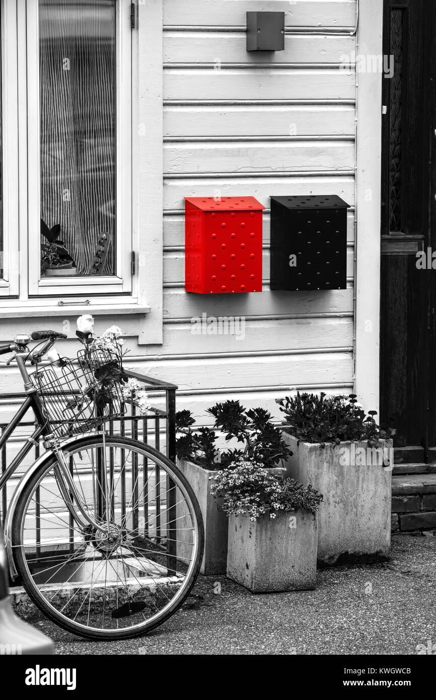 Wooden house with bike against red postboxes in Bergen. UNESCO World Heritage Site, Norway Stock Photo