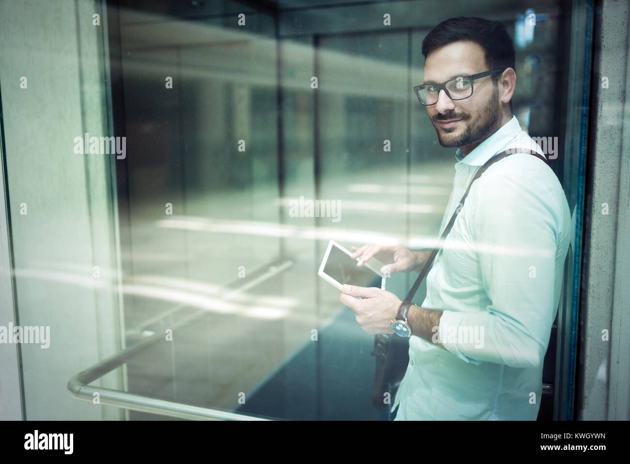 Handsome young businessman using his digital tablet Stock Photo - Alamy