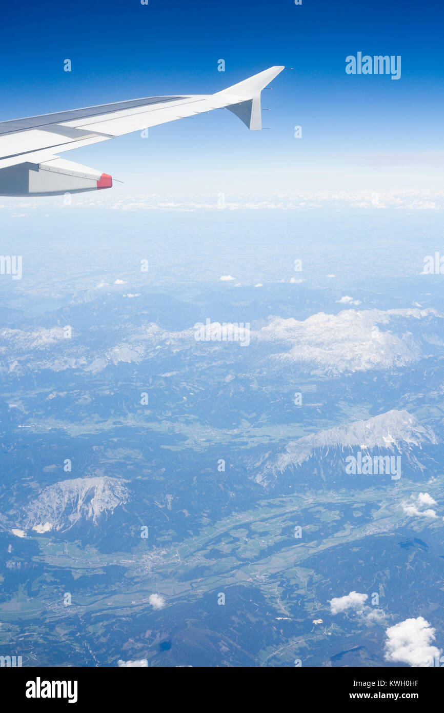 Air view of clouds, sky and airplane wing Stock Photo