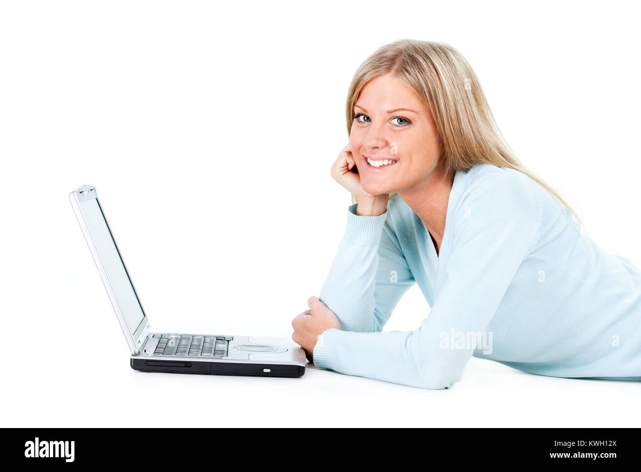 Blonde girl working on laptop, white background Stock Photo