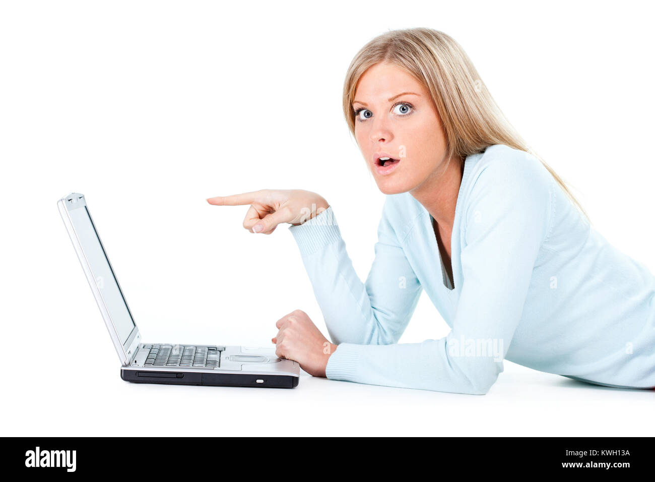 Beautiful blonde girl working on laptop, white background Stock Photo
