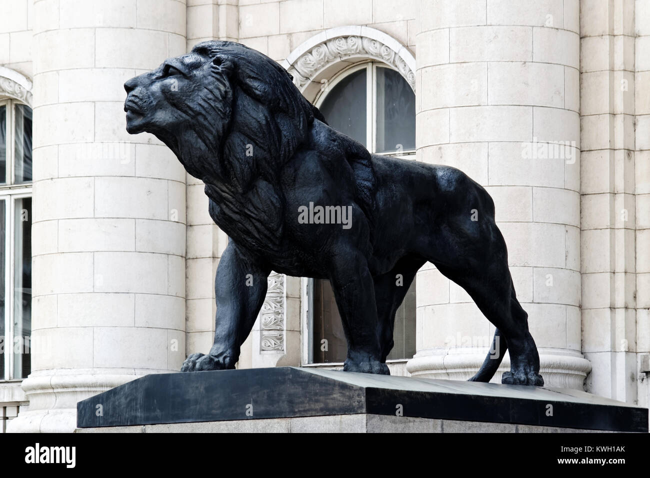 Sculpture of a lion with columns, arches of a building in classical style in background. Palace of Justice, Bulgaria, Sofia. Stock Photo