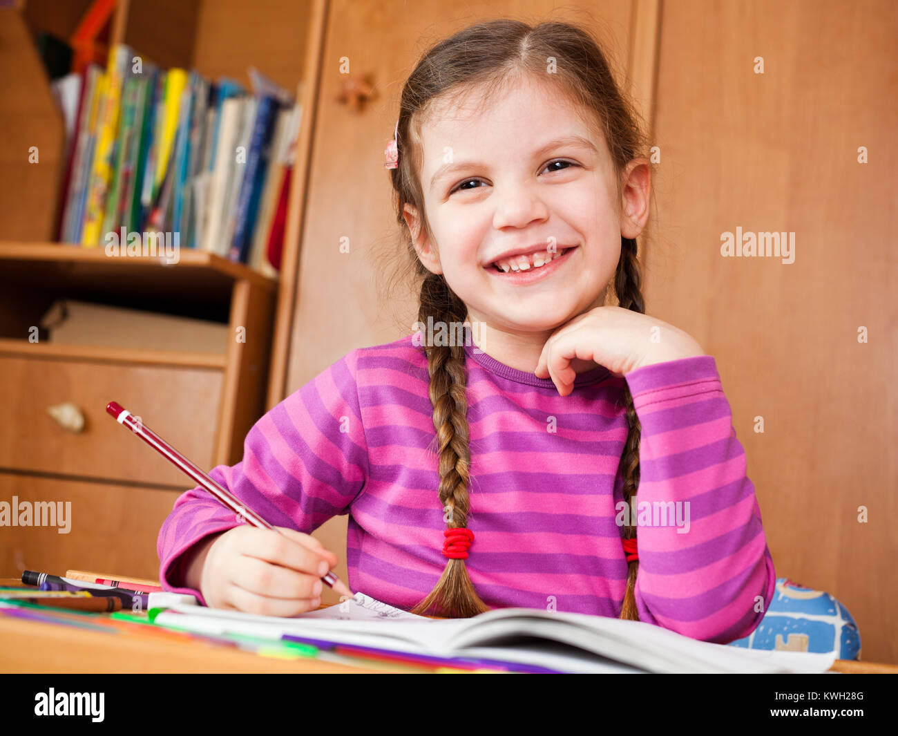 Preschooler child drawing in her room Stock Photo - Alamy