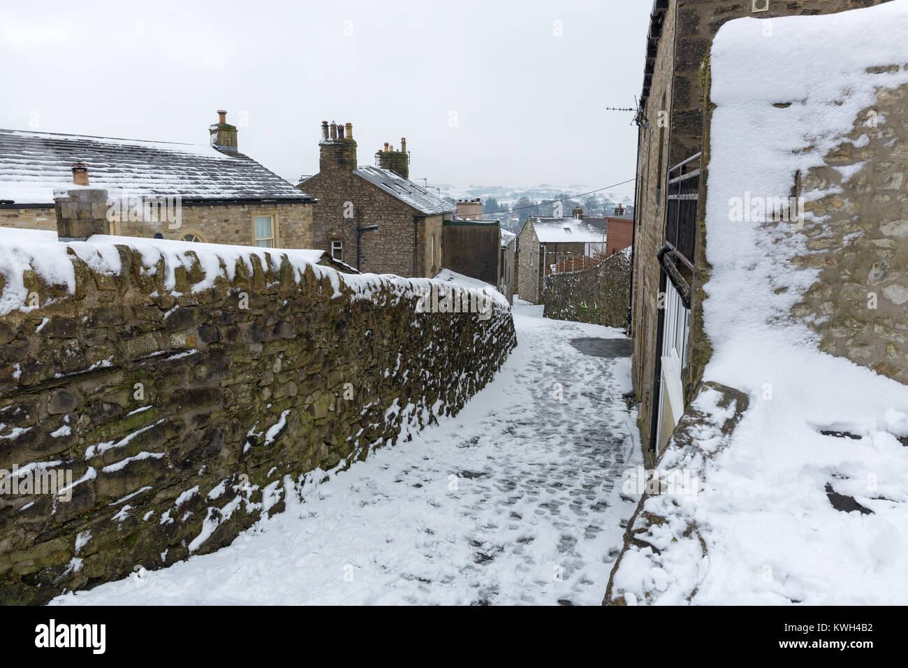 Winter snow scenes near the North Yorkshire village of Settle showing village life trapped by