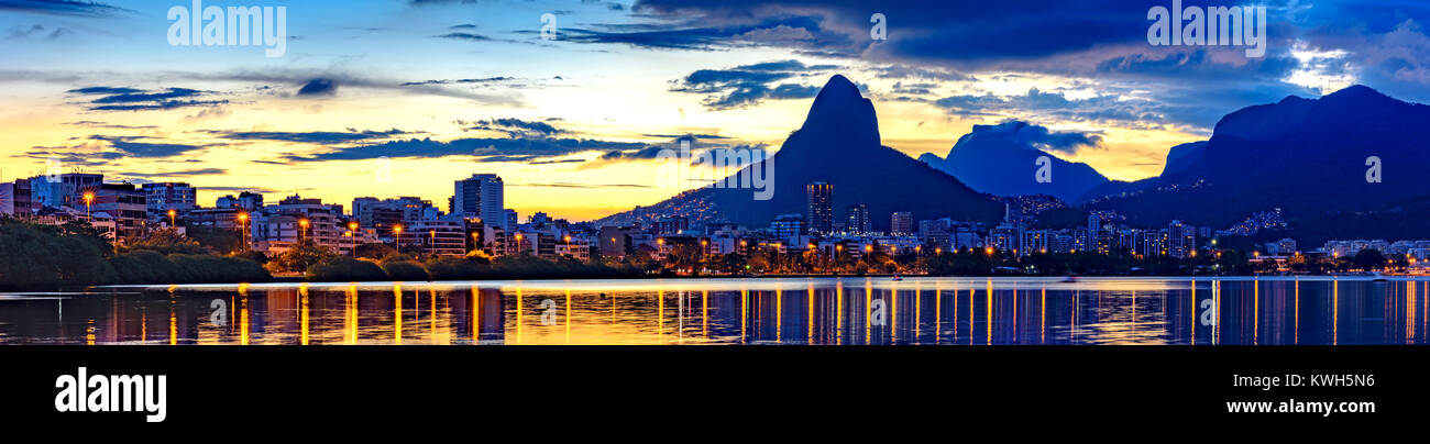 Panoramic image of the summer sunset  seen from the lagoon Rodrigo de Freitas with the buildings of the city of Rio de Janeiro, Stock Photo