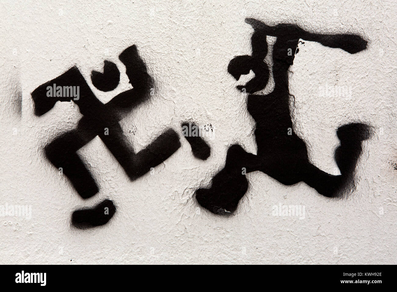 Graffiti in Maribor, Slovenia. The stencilled work depicts a swastika being clubbed. Stock Photo