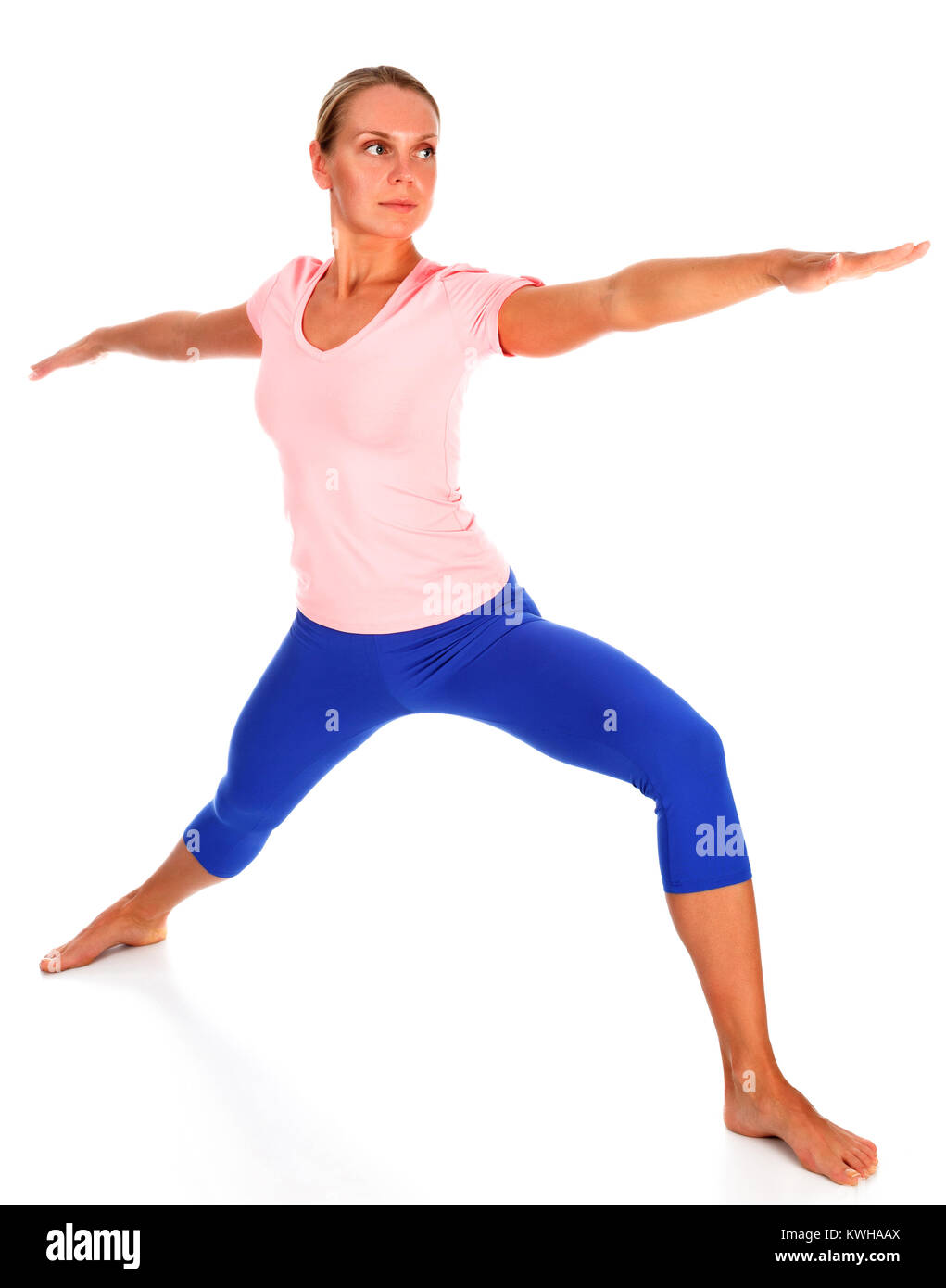 Beautiful sporty young woman practicing yoga warrior pose, isolated on white background Stock Photo