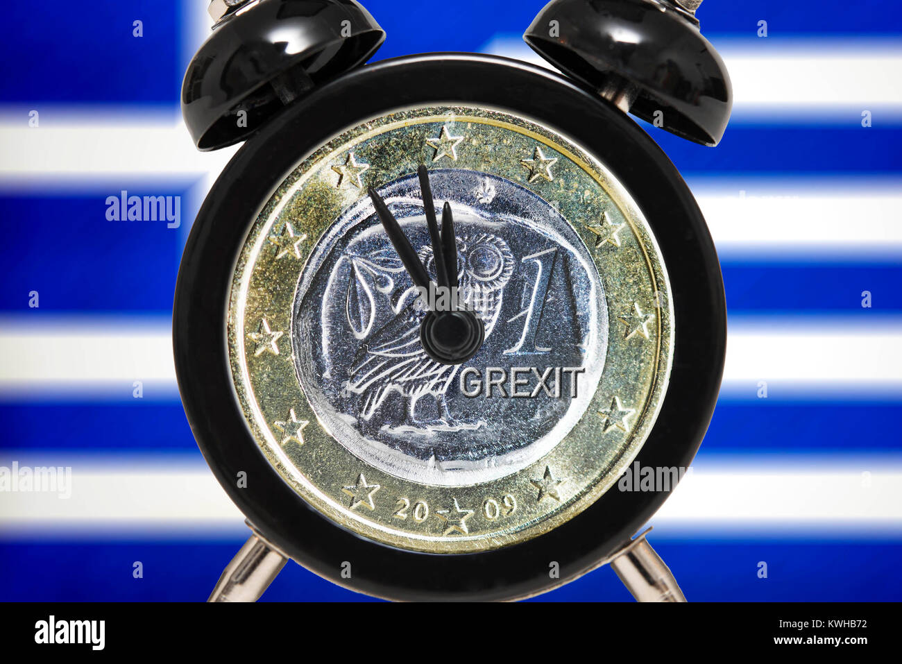 Alarm clock with Greek euro on Five before Twelve before Greece flag, symbolic photo debt quarrel, Wecker mit griechischem Euro auf FÃ¼nf vor ZwÃ¶lf v Stock Photo
