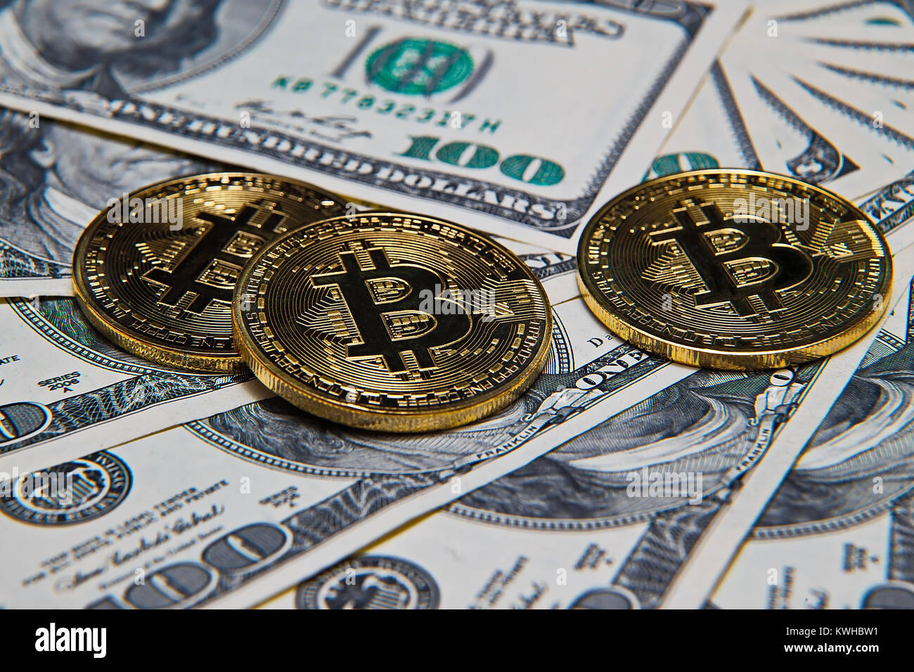 Bitcoins and dollars at office desk Stock Photo