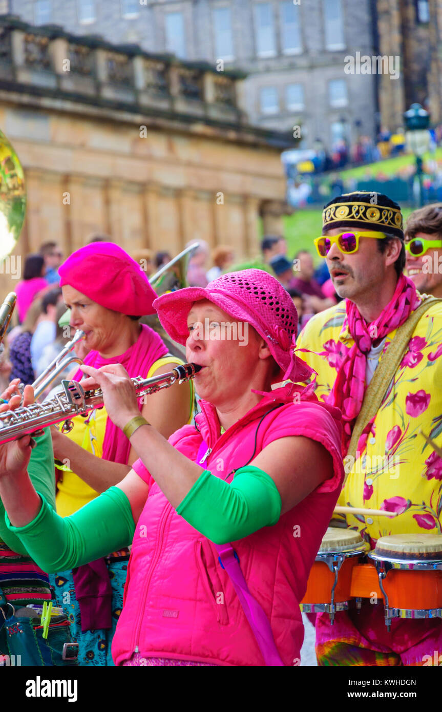 Female musician in pink playing a soprano saxophone in the Carnival of