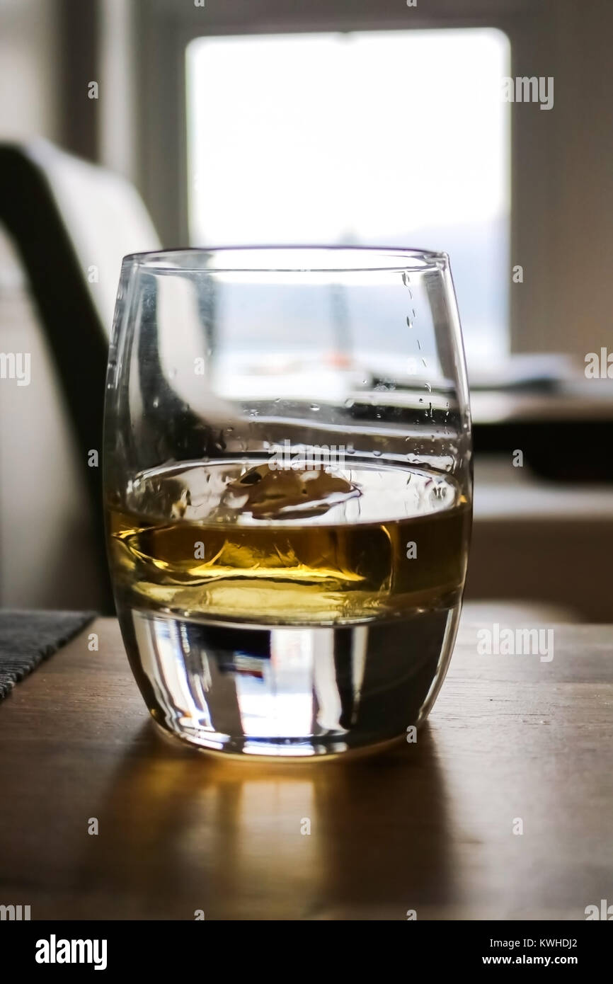 Glass of Whiskey with Sunlight Glowing Through Stock Photo