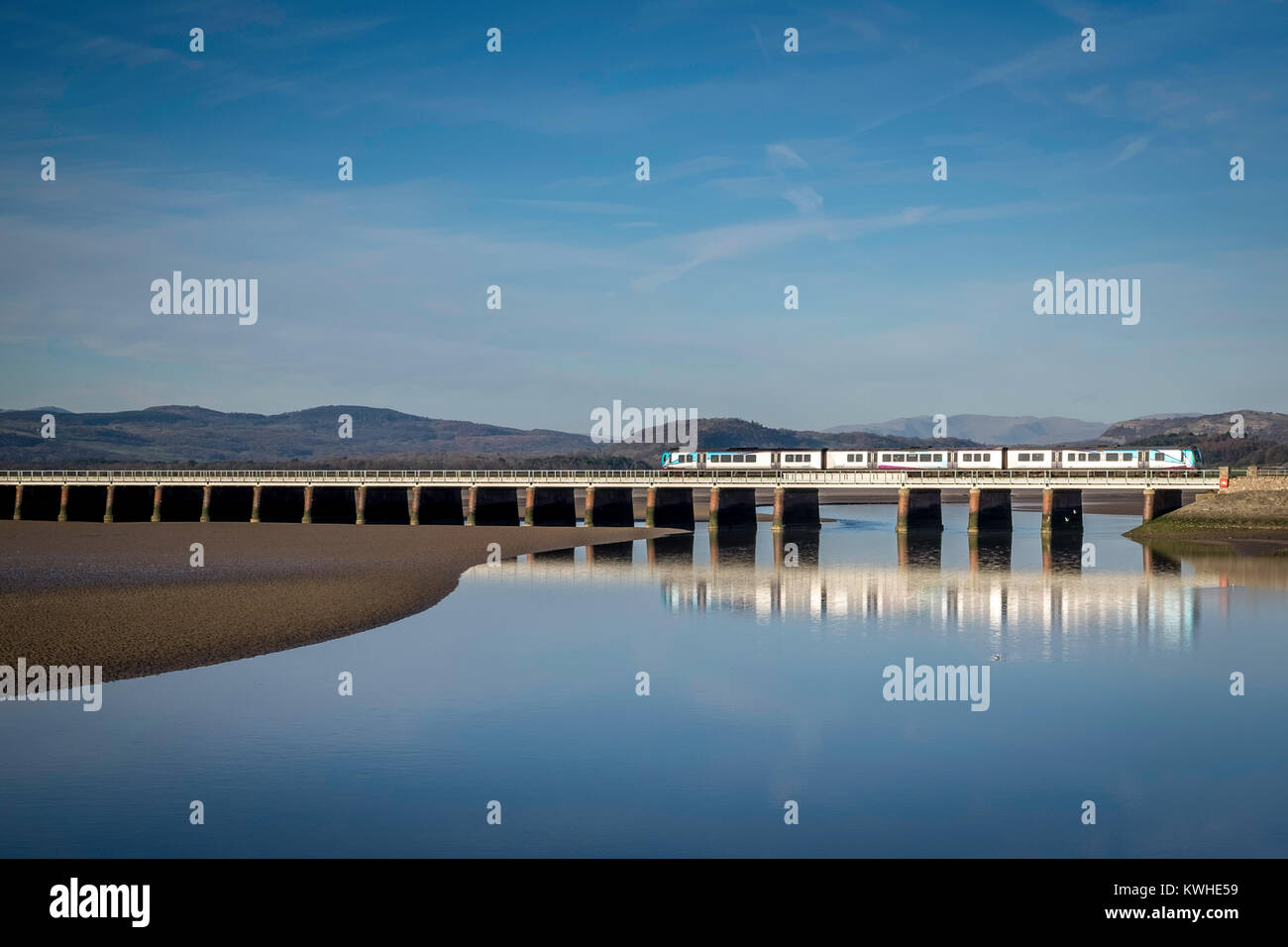 Northern train (Arriva Rail North) crossing the Kent Estuary at Arnside ...