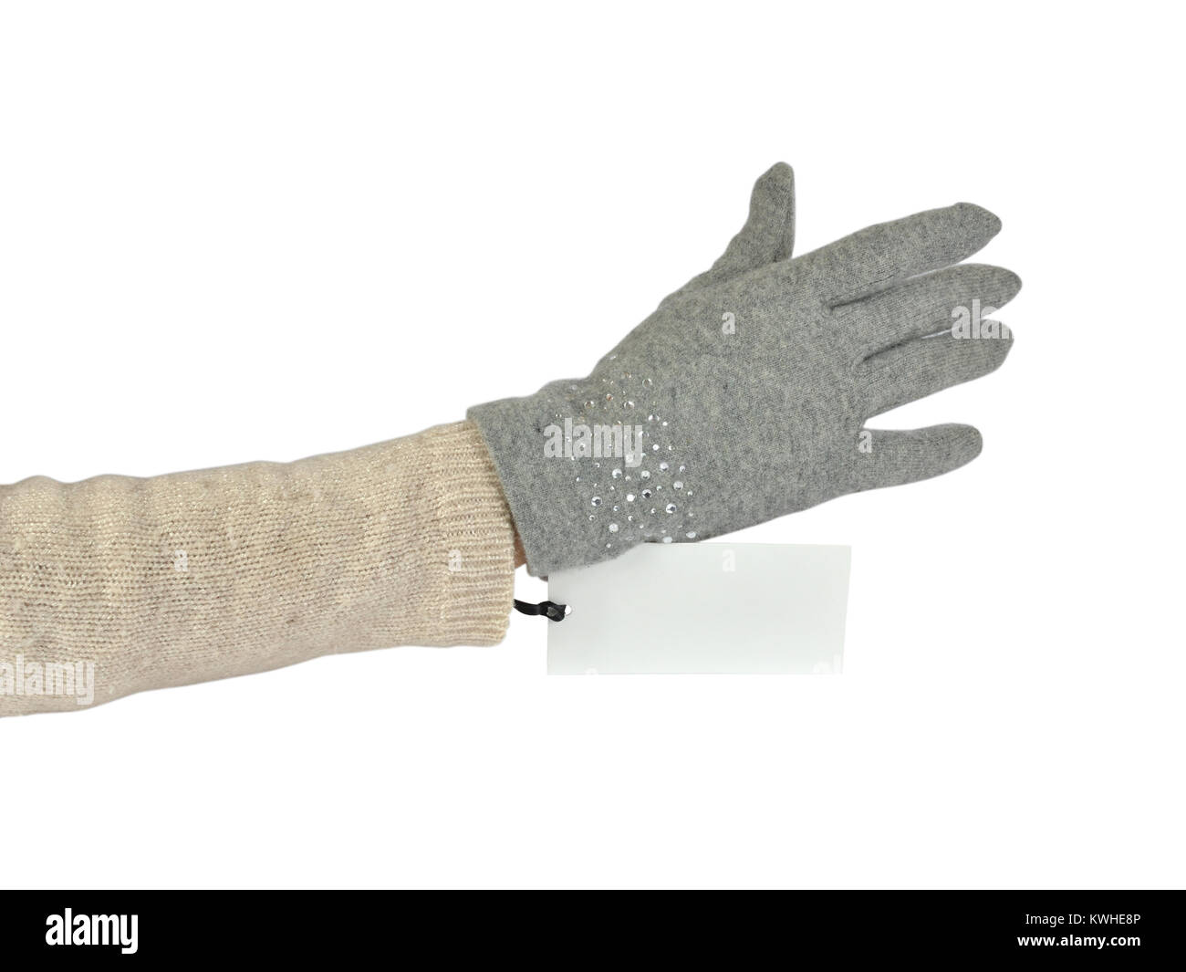 Grey woolen glove on a hand and a price tag on white background Stock Photo