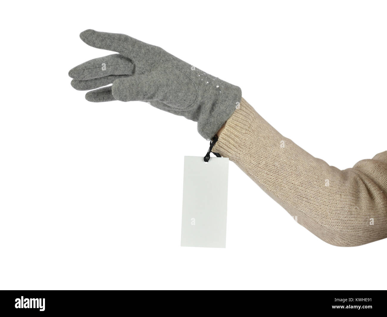 Woman's hand in a grey woolen glove with a price tag on white background Stock Photo