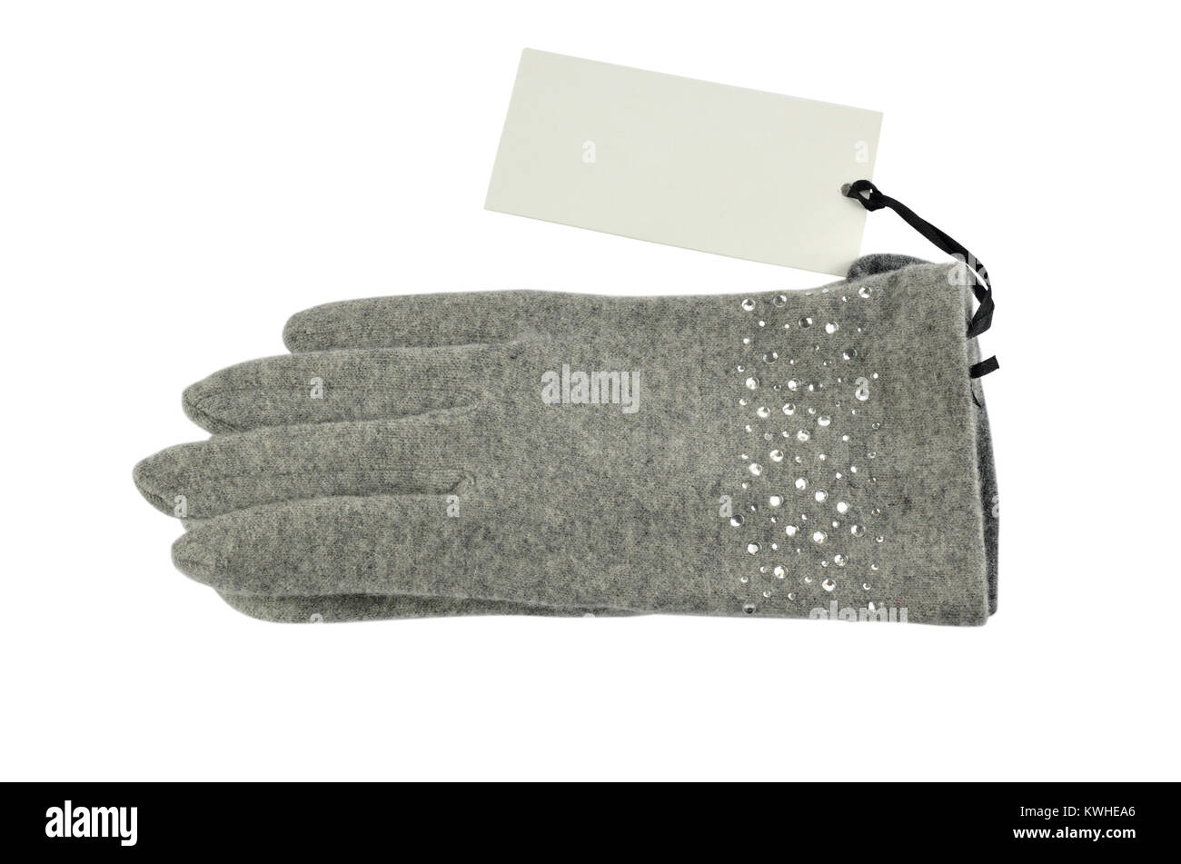 Grey woolen gloves with a blank price tag beside it, on white background Stock Photo
