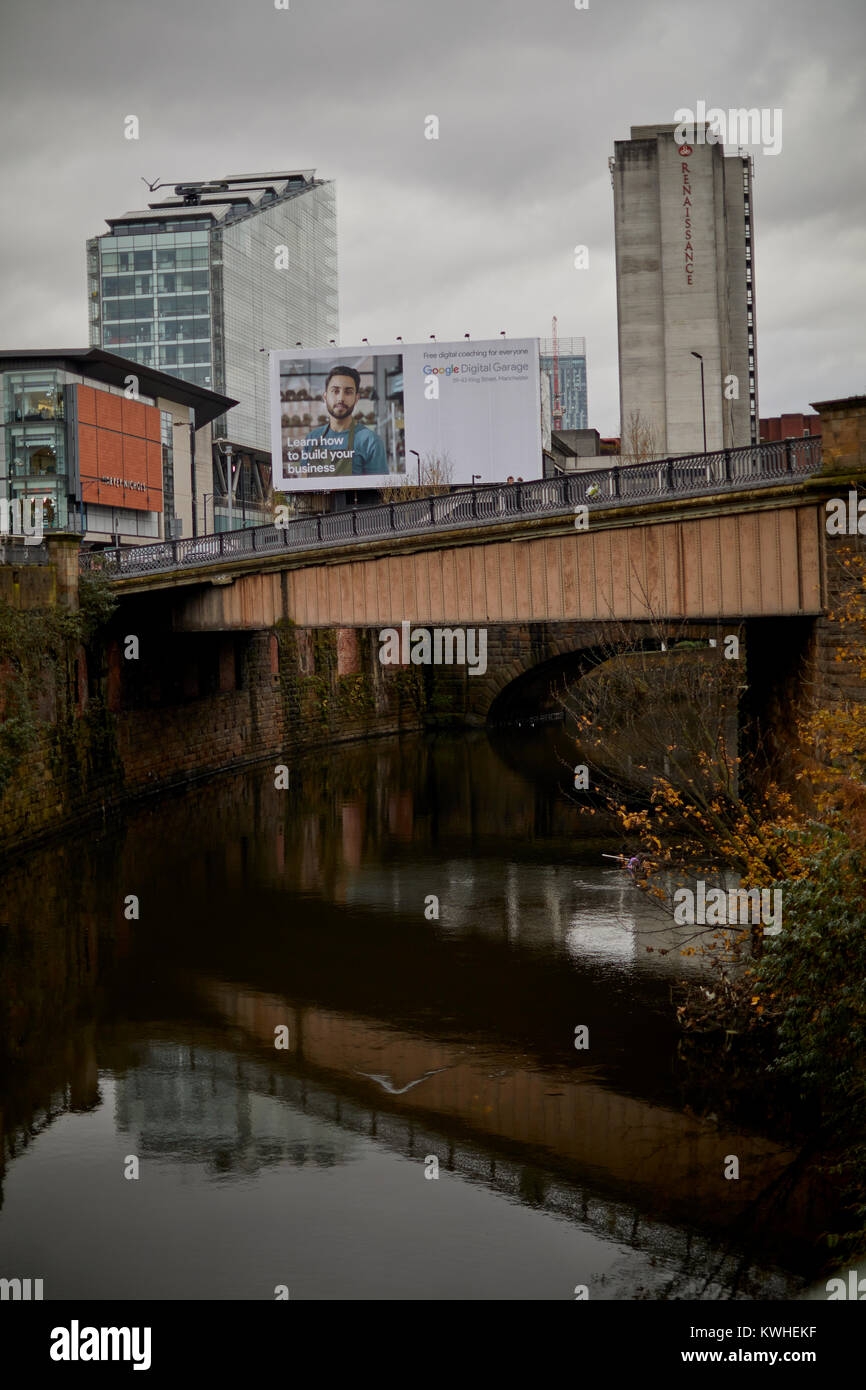 Manchester city centre, River Irwell, large advertisement billboard and the back of the Renascent hotel Stock Photo