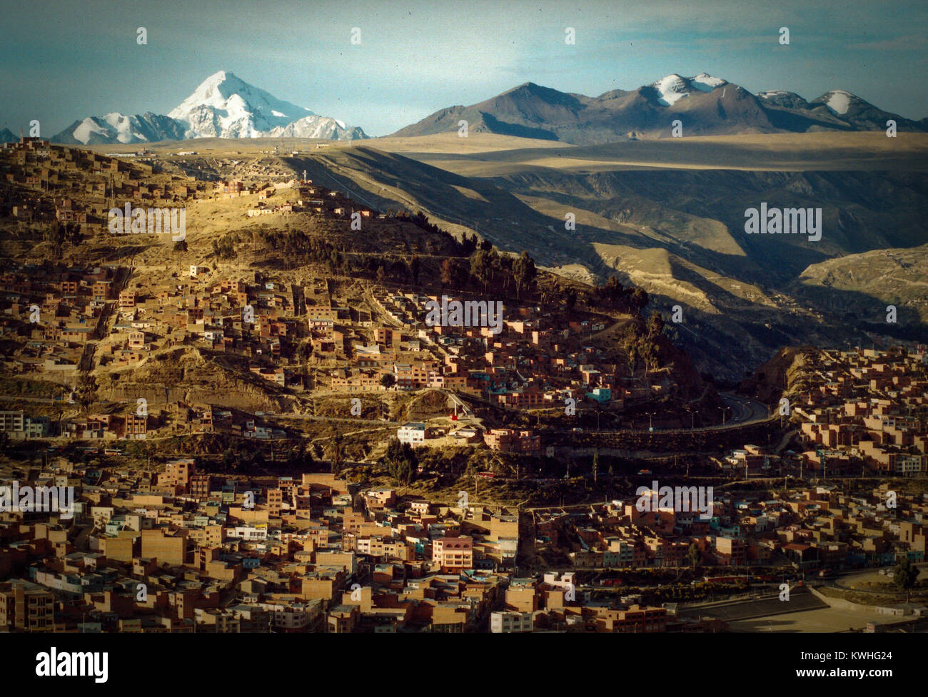 Houses in a town with a mountain range in the background, Macrodistrito Maximiliano Paredes, La Paz, Bolivia Stock Photo