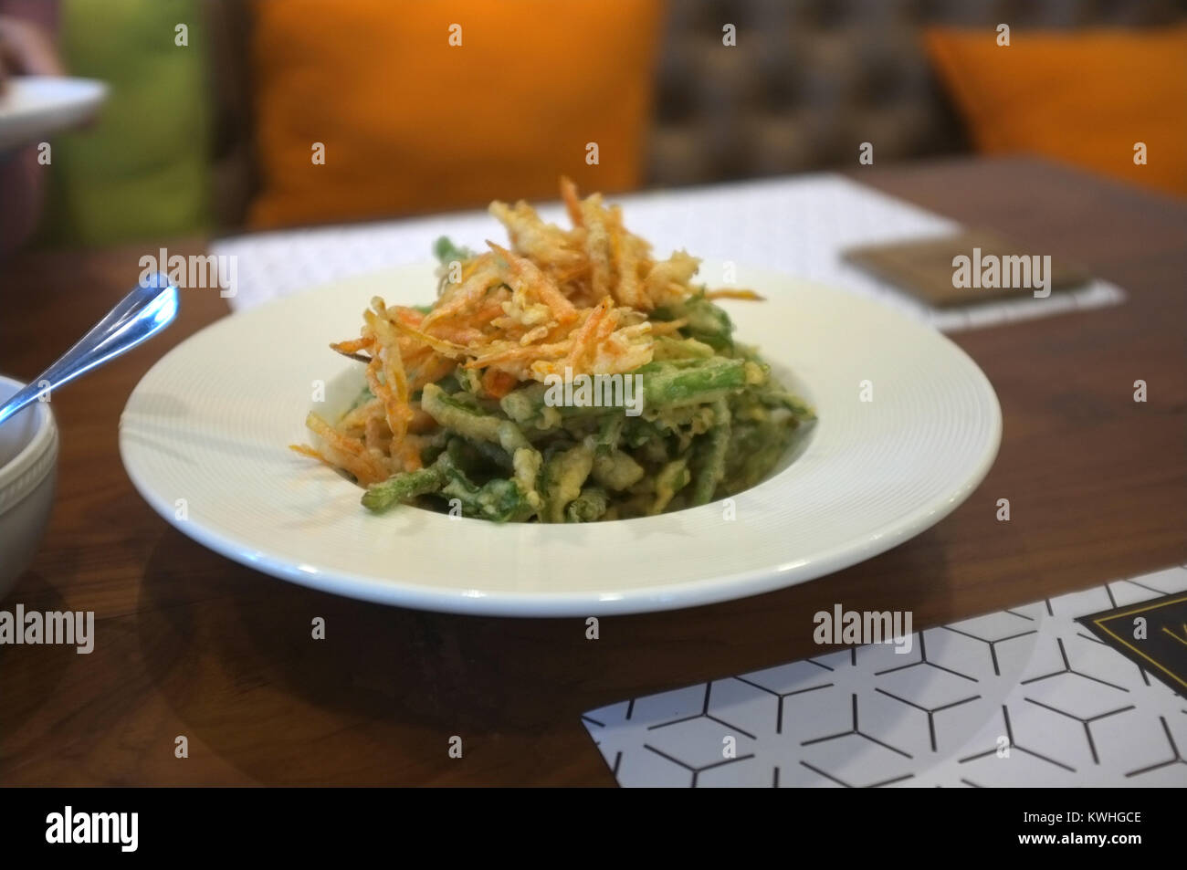 Thai cuisine, Deep fried morning glory and carrot with spicy salad sauce. Stock Photo