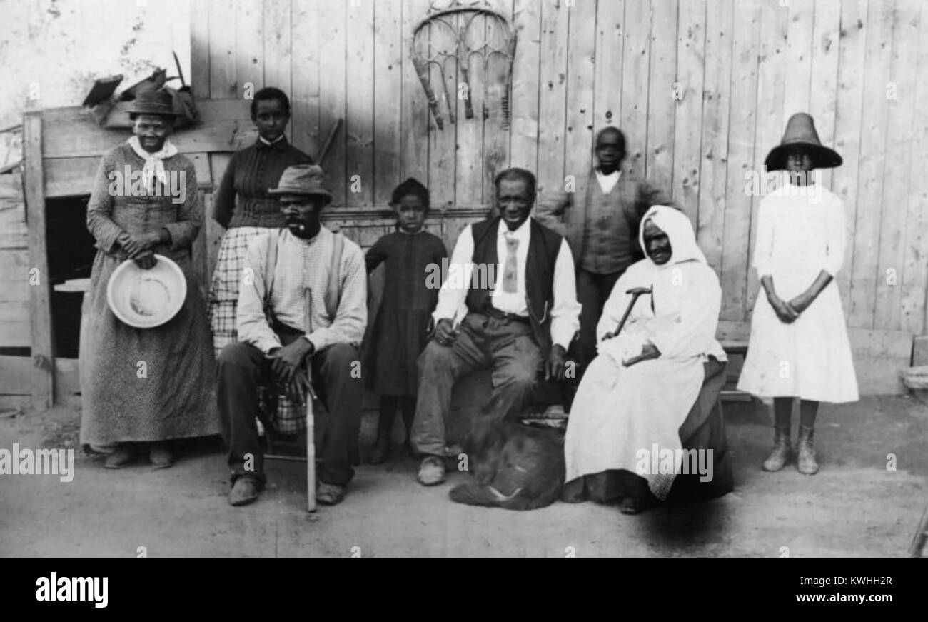 Former slave and Underground Railroad conductor Harriet Tubman (1822-1913), along with her husband, step-daughter, extended family, and former slaves she helped during the Civil War. From left to right: Harriet Tubman: Gertie Davis (Tubman's adopted daughter), Nelson Davis (Tubman's husband), Lee Cheney, 'Pop' Alexander, Walter Green, Sarah Parker ('Blind Auntie' Parker) and Dora Stewart (granddaughter of Tubman's brother, John Stewart). Photo by William Cheney, c1880s. Stock Photo