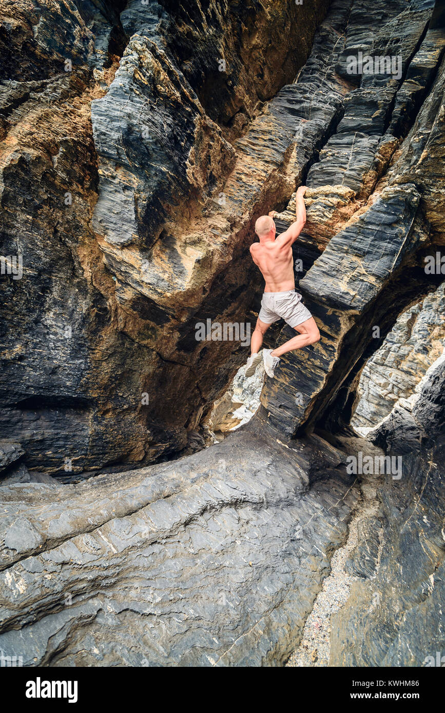 Man climbing up rock at Rapid Bay, South Australia Stock Photo Alamy