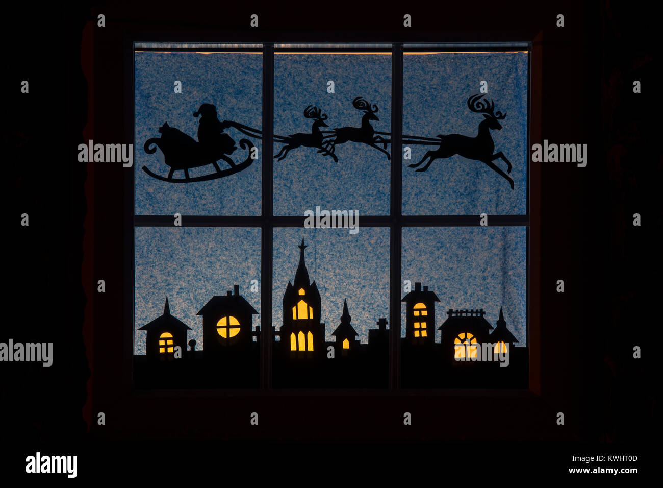 Festive Christmas Santa Claus and reindeer house window display silhouette. Northamptonshire, England Stock Photo