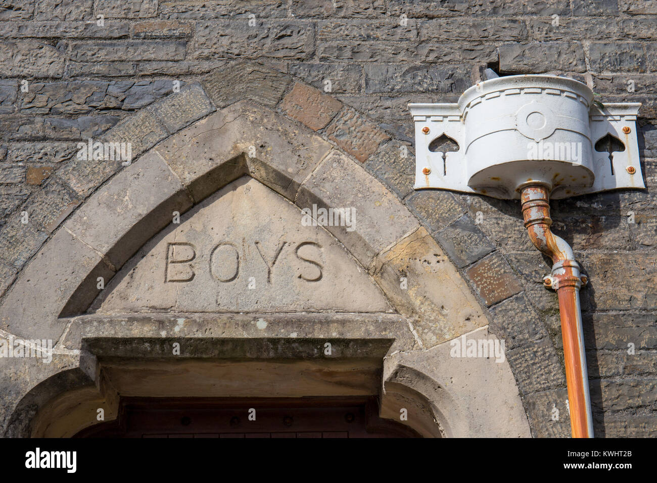 Boys school sign above entrance with downpipe Stock Photo