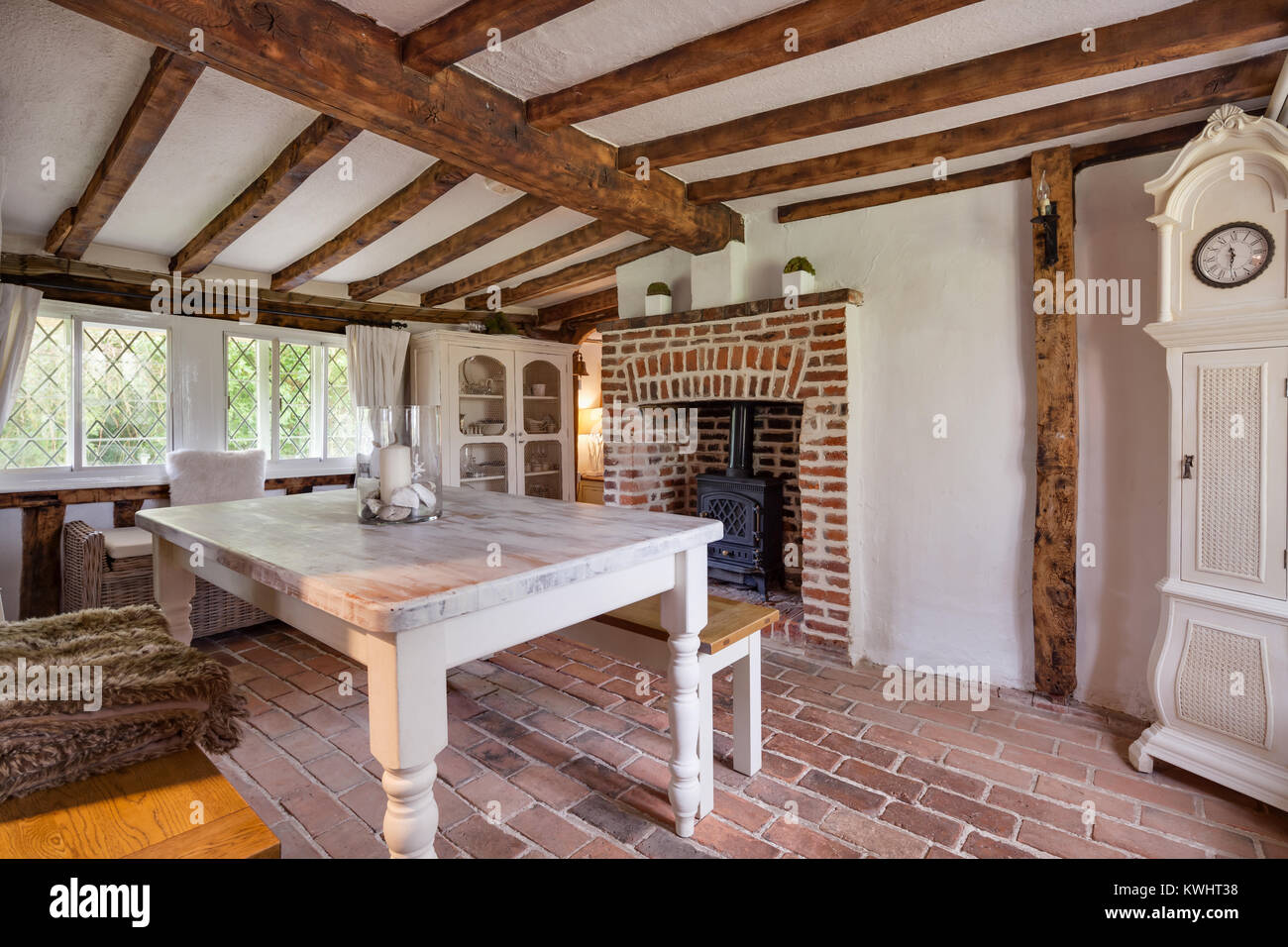 Tastefully modernised dining room withing 16th Century English cottage with traditionally styled decor sympathetic to the original period with dining  Stock Photo