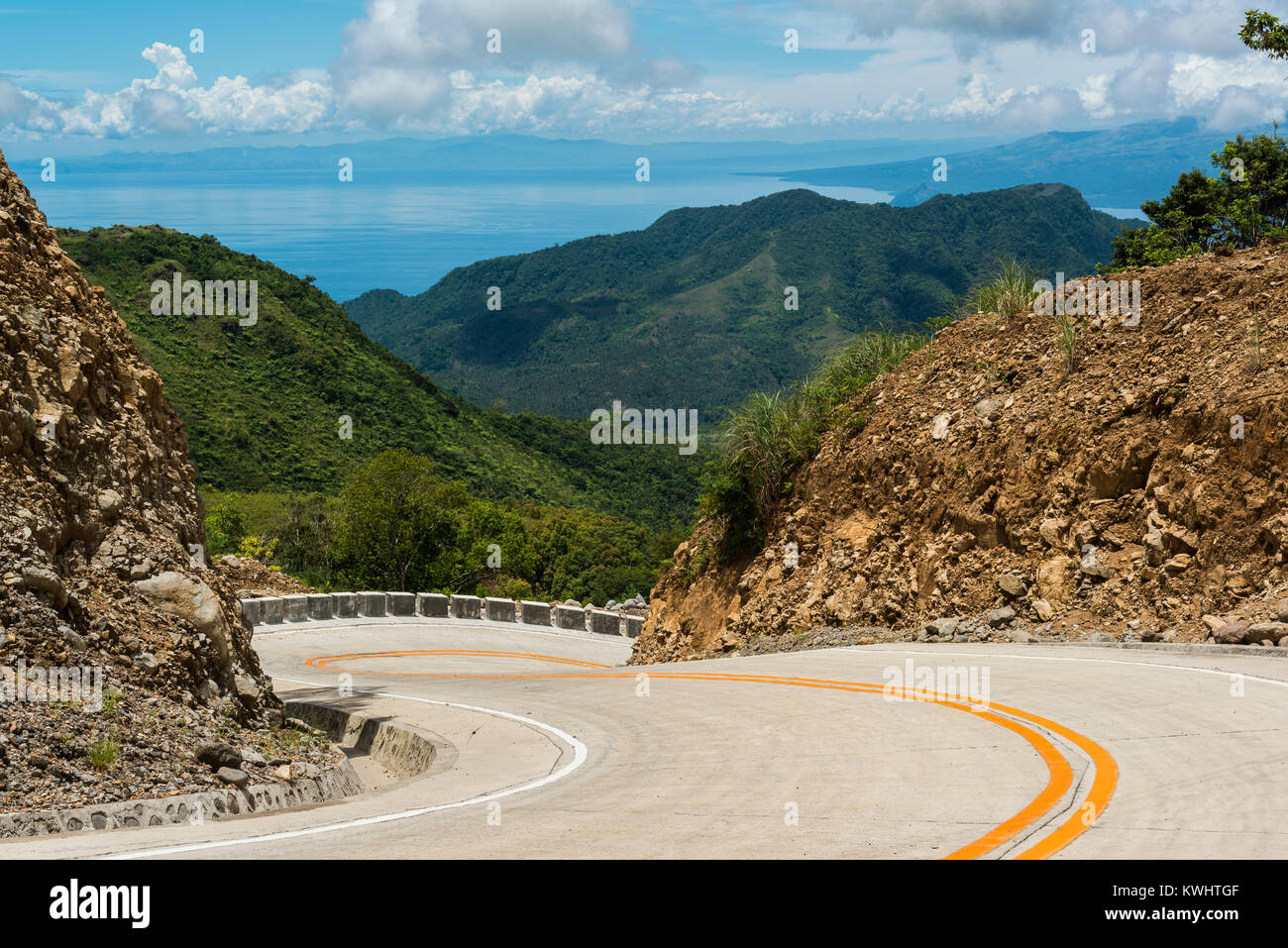 Winding Road Leading Down A Steep Mountain With A Beautiful View Over